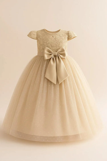 Beige flower girl dress with a large bow on a beige background